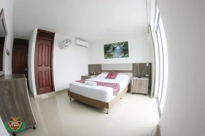 a bedroom with a bed in a white room at Hotel La Roca San Rafael in San Rafael