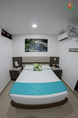 a bedroom with a large bed and two tables at Hotel La Roca San Rafael in San Rafael
