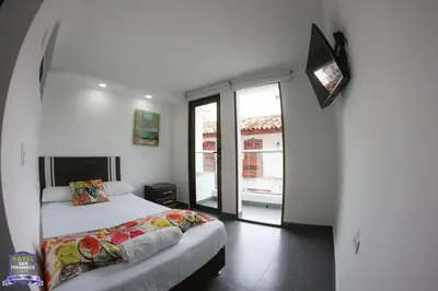 a bedroom with a bed and a sliding glass door at Hotel San Fernandos Plaza in San Rafael