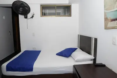 a bedroom with a bed and a desk and a window at Hotel San Fernandos Plaza in San Rafael