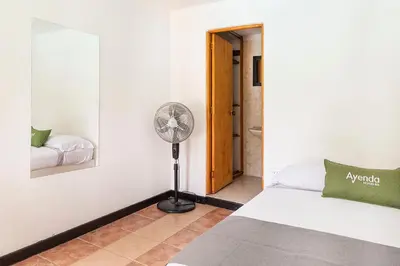 a bedroom with a fan next to a bed at Hotel Premium Real in Medellín