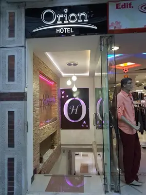 a man standing in front of a store at Hotel Orion in Chinchiná