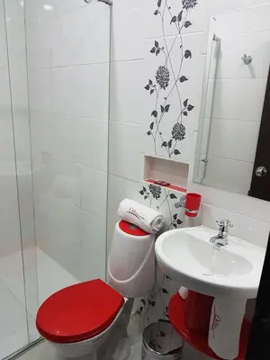 a bathroom with a toilet and a sink at Hotel Orion in Chinchiná