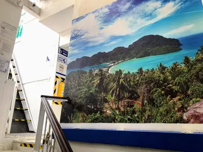 a mural of a tropical island on a wall in a room at Casa Hotel Manco Mora in Medellín