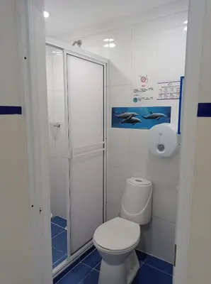 a white bathroom with a toilet and a shower at Casa Hotel Manco Mora in Medellín