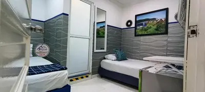 a small room with two beds and a mirror at Casa Hotel Manco Mora in Medellín