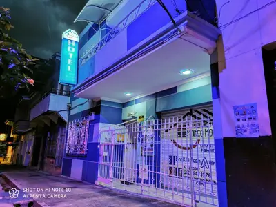 a store front with purple lights on a street at Casa Hotel Manco Mora in Medellín