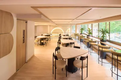 a restaurant with tables and chairs and windows at Hotel Lincoln in Medellín