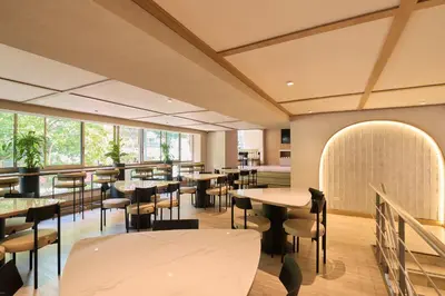 a restaurant with tables and chairs and windows at Hotel Lincoln in Medellín