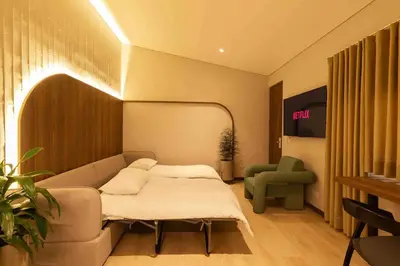 a living room with a couch and a chair at Hotel Lincoln in Medellín