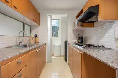 a kitchen with a sink and a counter top at Affinity ApartaHotel - Extended Stay in Medellín