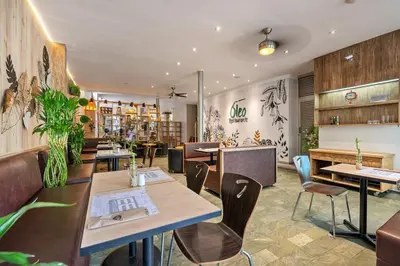 a restaurant with tables and chairs in a room at Affinity ApartaHotel - Extended Stay in Medellín