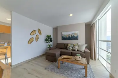 a living room with a couch and a table at Affinity ApartaHotel - Extended Stay in Medellín