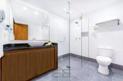 a bathroom with a sink and a toilet and a shower at Leblon Suites Hotel Milla de Oro in Medellín