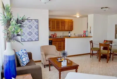a living room with a couch and a table at Portal del Rodeo ApartaHotel - Arkadia Mall in Medellín