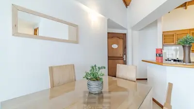 a dining room with a glass table and chairs at Portal del Rodeo ApartaHotel - Arkadia Mall in Medellín