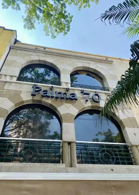 a building with a sign that reads palma at Hotel Palma 70 in Medellín