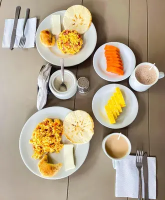 a table with four plates of food on it at Hotel Palma 70 in Medellín