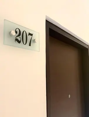 a sign above a door with the number at Hotel Palma 70 in Medellín