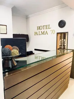 a hotel palma lobby with a glass counter top at Hotel Palma 70 in Medellín