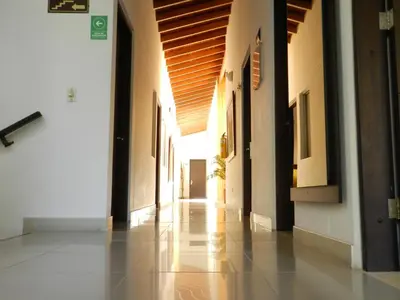 an empty hallway of a building with a wooden ceiling at Hotel Palma 70 in Medellín