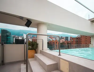 a balcony of a building with a swimming pool at Sites Hotel in Medellín