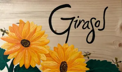 a picture of two yellow flowers on a cutting board at 40 Amigos Hotel in Jardin