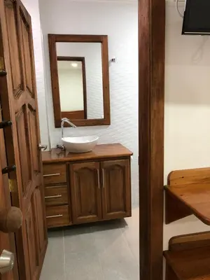 a bathroom with a sink and a mirror at 40 Amigos Hotel in Jardin