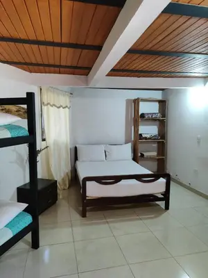 a bedroom with a bed and a book shelf at Alojamiento Rural Altos del Molino in Los Andes