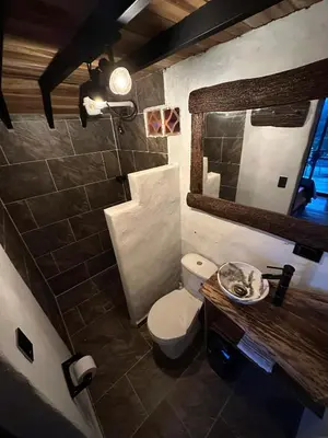 a bathroom with a toilet and a sink and a mirror at Alojamiento Rural Altos del Molino in Los Andes