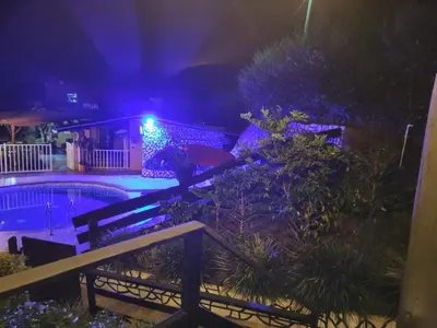 a house with a swimming pool at night at Alojamiento Rural Altos del Molino in Los Andes