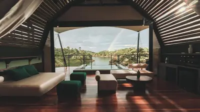 a living room with a view of the water at Bosko in Guatapé