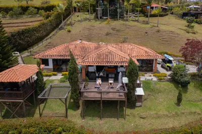 an aerial view of a house with two people on a deck at CASA CAMPESTRE MONTECARLO Guatapé- desayuno a pareja in Guatapé