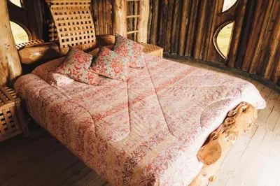 a bedroom with a bed with a wooden bed frame at Hostal La Laguna in Villamaría
