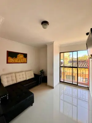 a living room with a couch and a large window at Hotel Portal Dorado in Marinilla