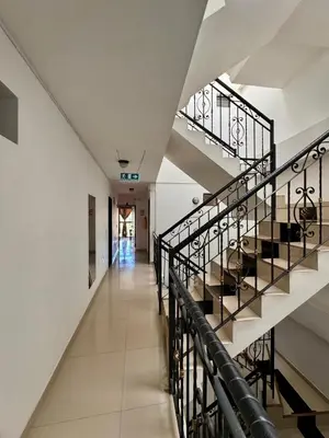 an empty hallway with stairs in a building at Hotel Portal Dorado in Marinilla