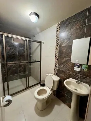 a bathroom with a toilet and a sink at Hotel Portal Dorado in Marinilla