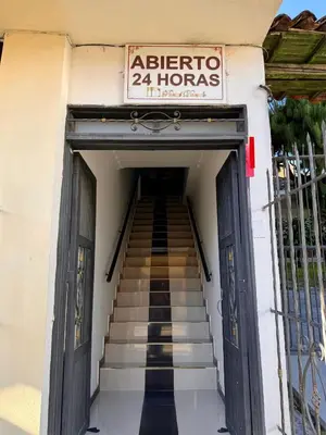 a set of stairs leading up to a building with a sign at Hotel Portal Dorado in Marinilla
