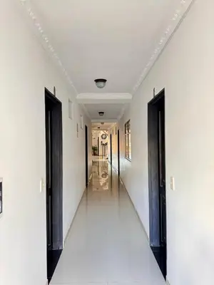 a hallway with black doors and white walls at Hotel Portal Dorado in Marinilla