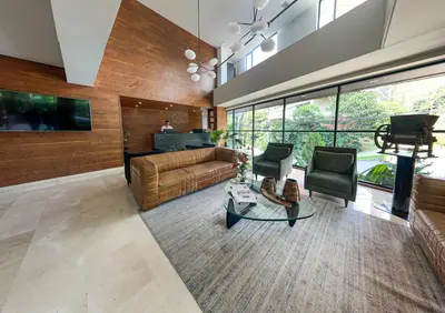 a large living room with a couch and chairs at Cafe Hotel Medellín in Medellín