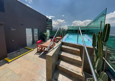 a swimming pool on the roof of a building at Cafe Hotel Medellín in Medellín