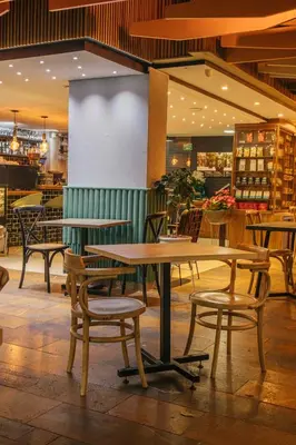 a group of tables and chairs in a restaurant at Cafe Hotel Medellín in Medellín