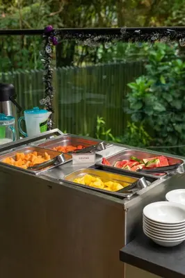 a buffet with many different types of food in trays at Cafe Hotel Medellín in Medellín