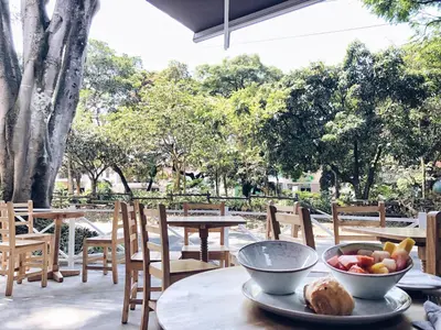 a table with a bowl of fruit on top of it at 574 Hotel in Medellín