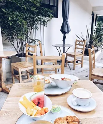 a wooden table with plates of food on it at 574 Hotel in Medellín