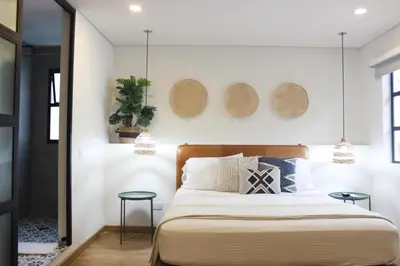 a bedroom with a large bed with two tables at 574 Hotel in Medellín