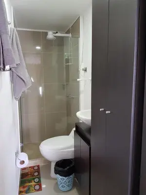 a small bathroom with a toilet and a sink at Apartasuites Medellin Los Molinos in Medellín