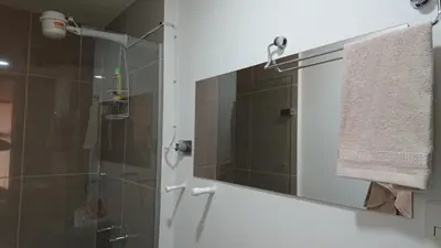 a bathroom with a shower and a mirror at Apartasuites Medellin Los Molinos in Medellín