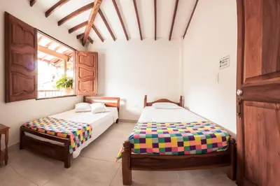 a bedroom with two beds and a window at Vivienda turística mi sueño Jardín in Jardin