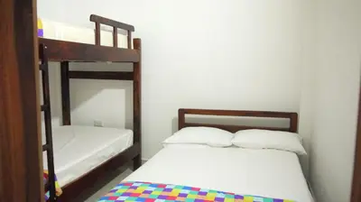 a bedroom with two bunk beds and a mirror at Vivienda turística mi sueño Jardín in Jardin